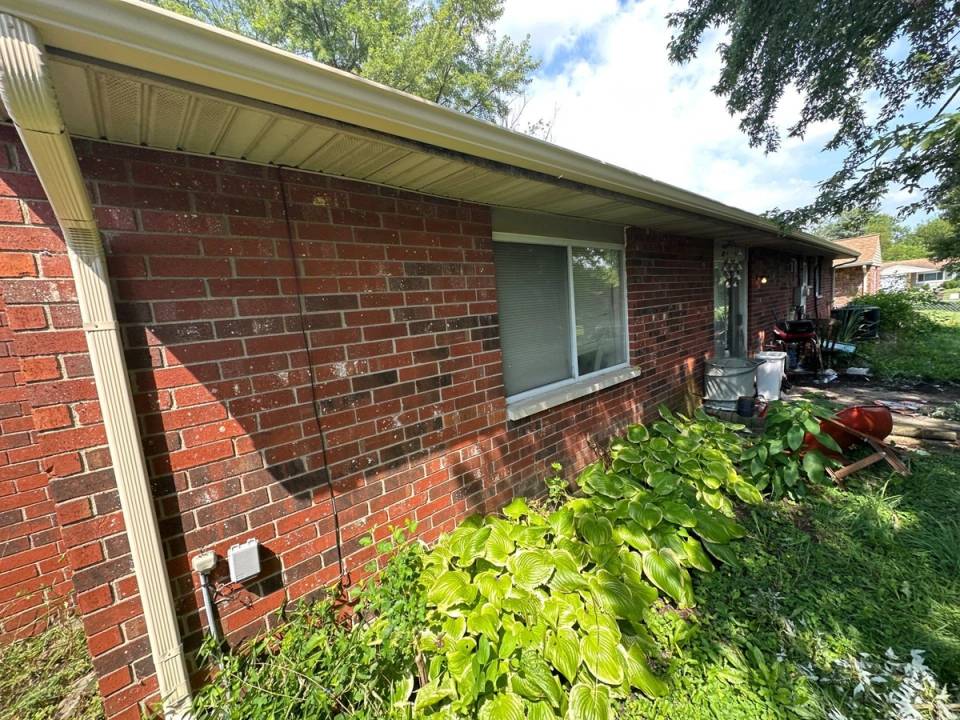 A new seamless gutter along the side of the brick house, Xenia, Ohio.