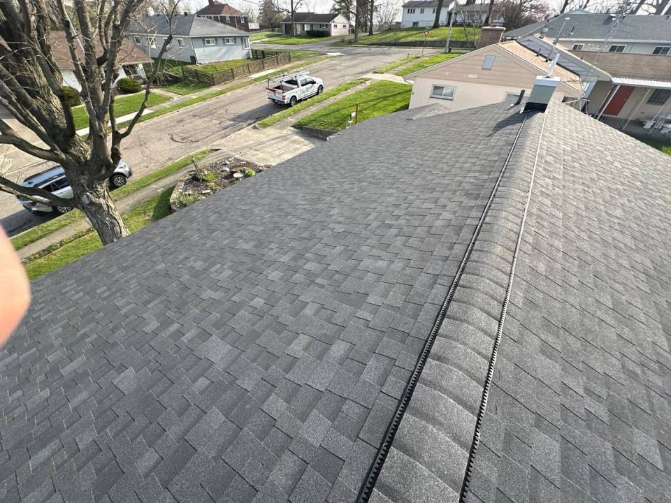 The finished Owens Corning Duration roof and ridge vent over the street, Dayton, Ohio.