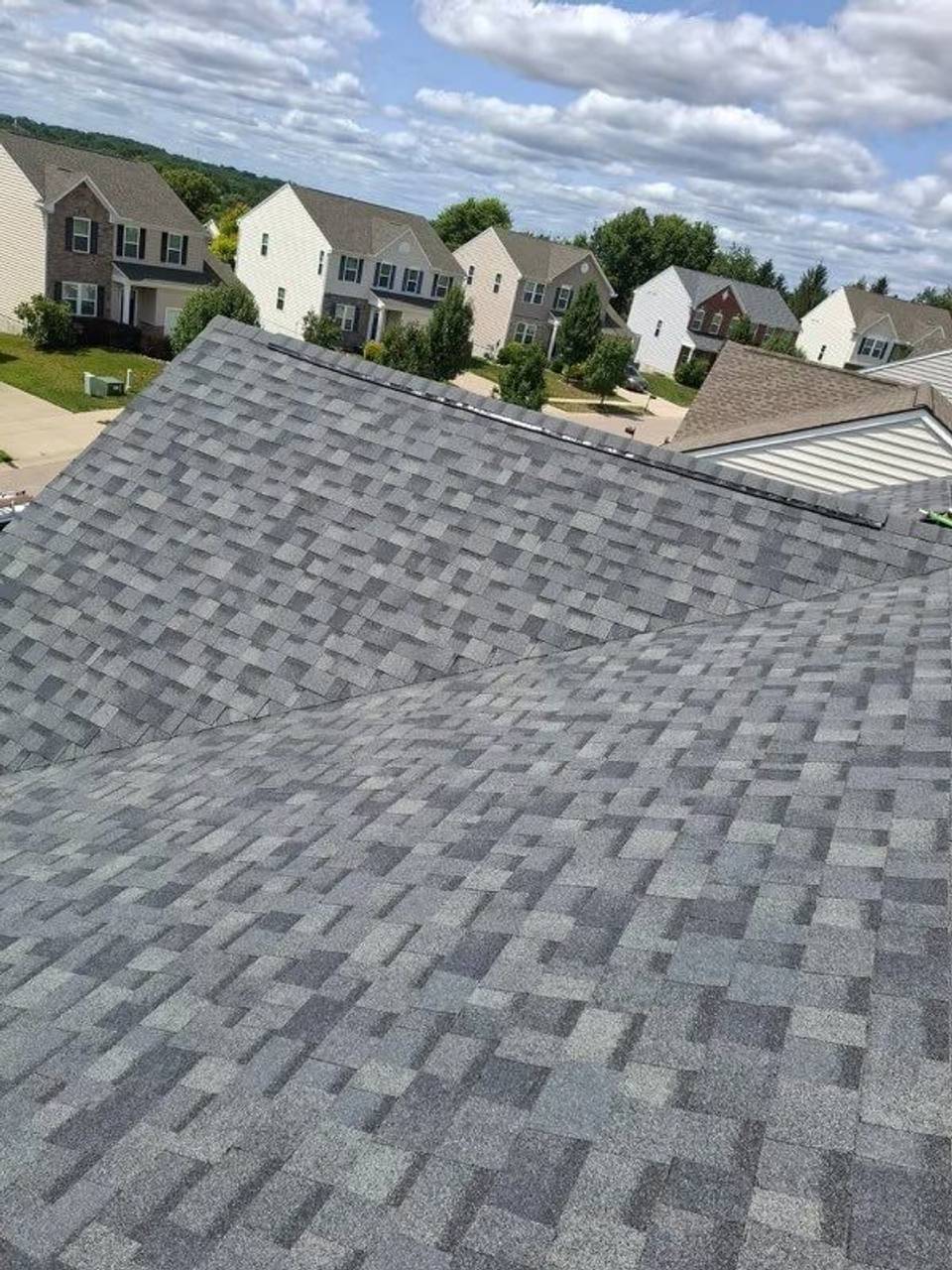 Drone photo of the finished gray shingle roof above the neighborhood, Xenia, Ohio.