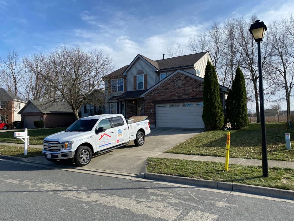 The two-story house with its new roof and the company truck in the drive, Fairborn, Ohio.