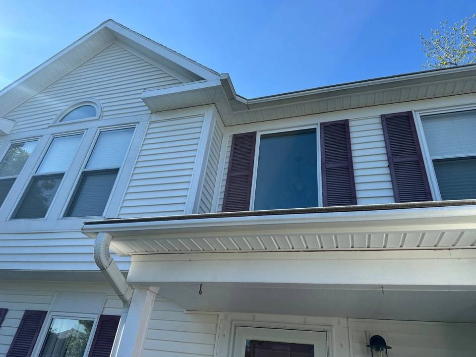 New soffit and trim across the front, below the arched window, Bellbrook, Ohio.