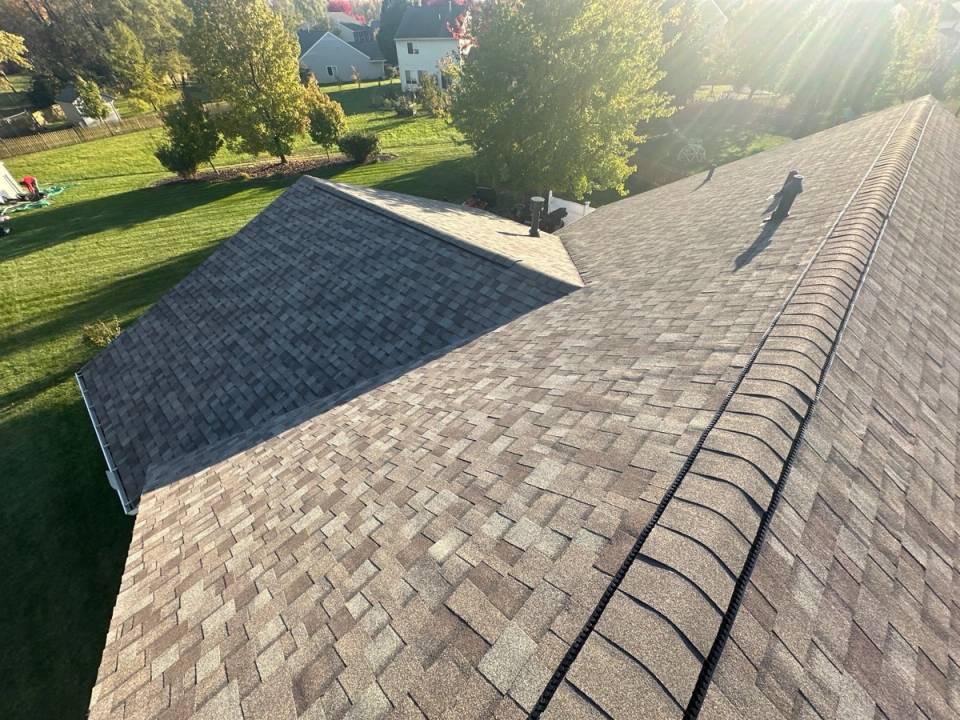 The finished roof in Owens Corning Duration Driftwood shingles, the ridge cap running toward the back lawn, Beavercreek, Ohio.
