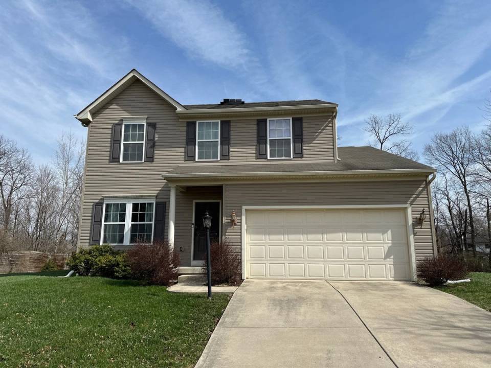 The two-story house with its attached garage, before the storm damage roof replacement, Beavercreek, Ohio.